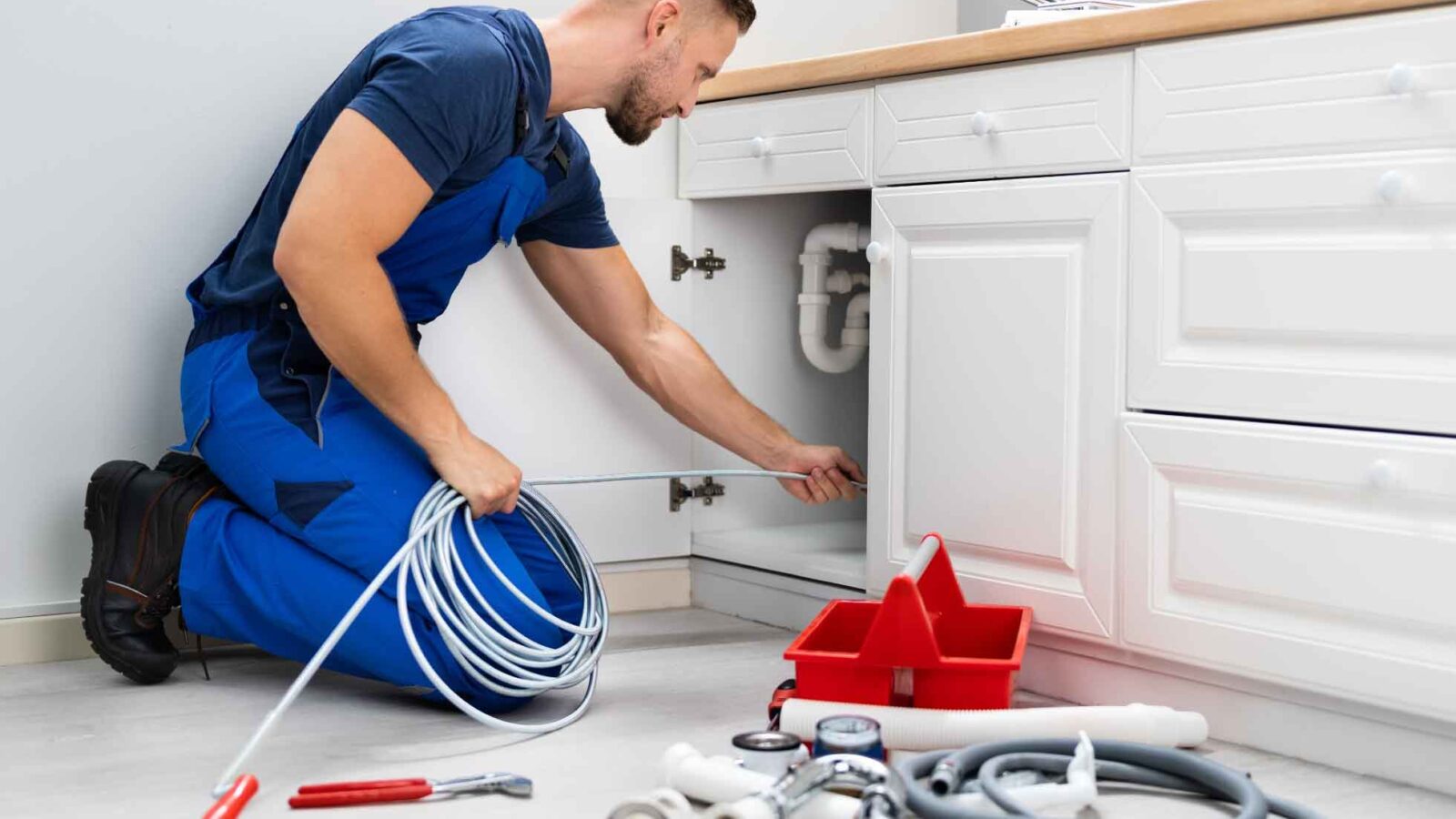 Property Management - Maintenance person working on sink
